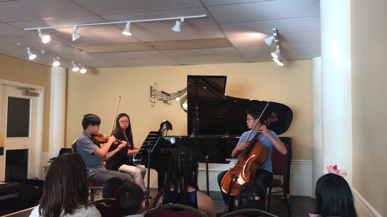 Students performing a chamber piece on stage during a Fallbrooke Piano Academy recital