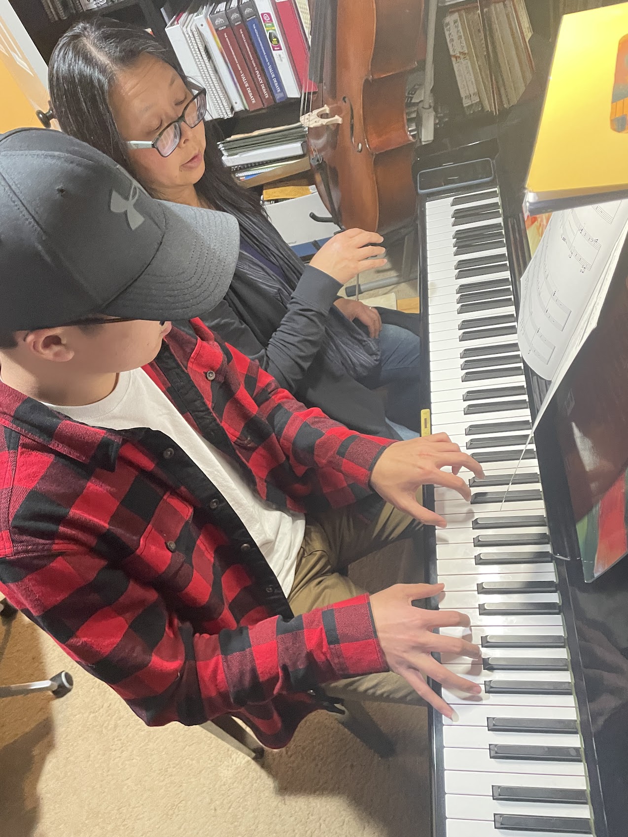 A teen student working through advanced repertoire under Theresa's guidance